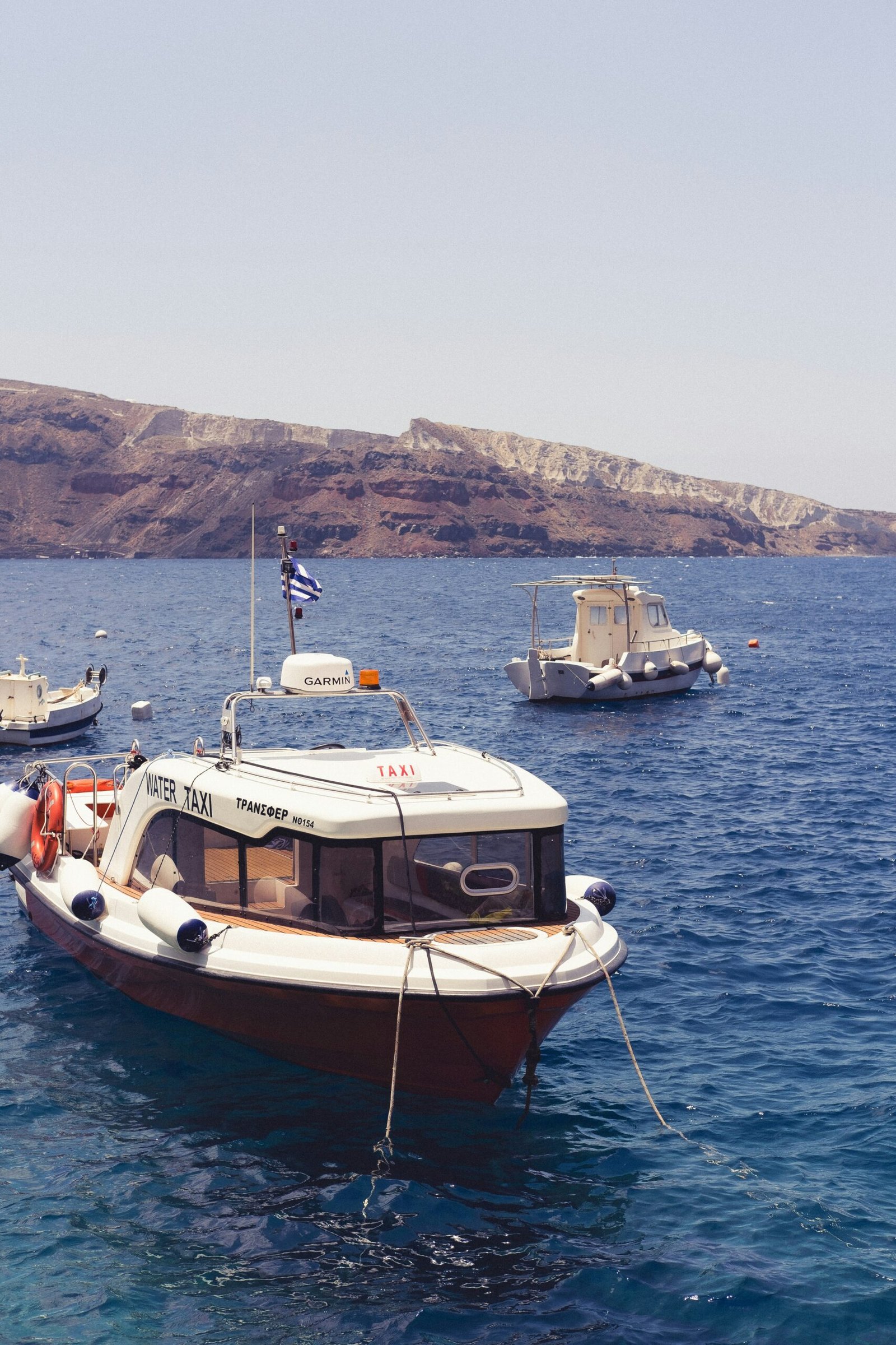 A group of boats floating on top of a body of water