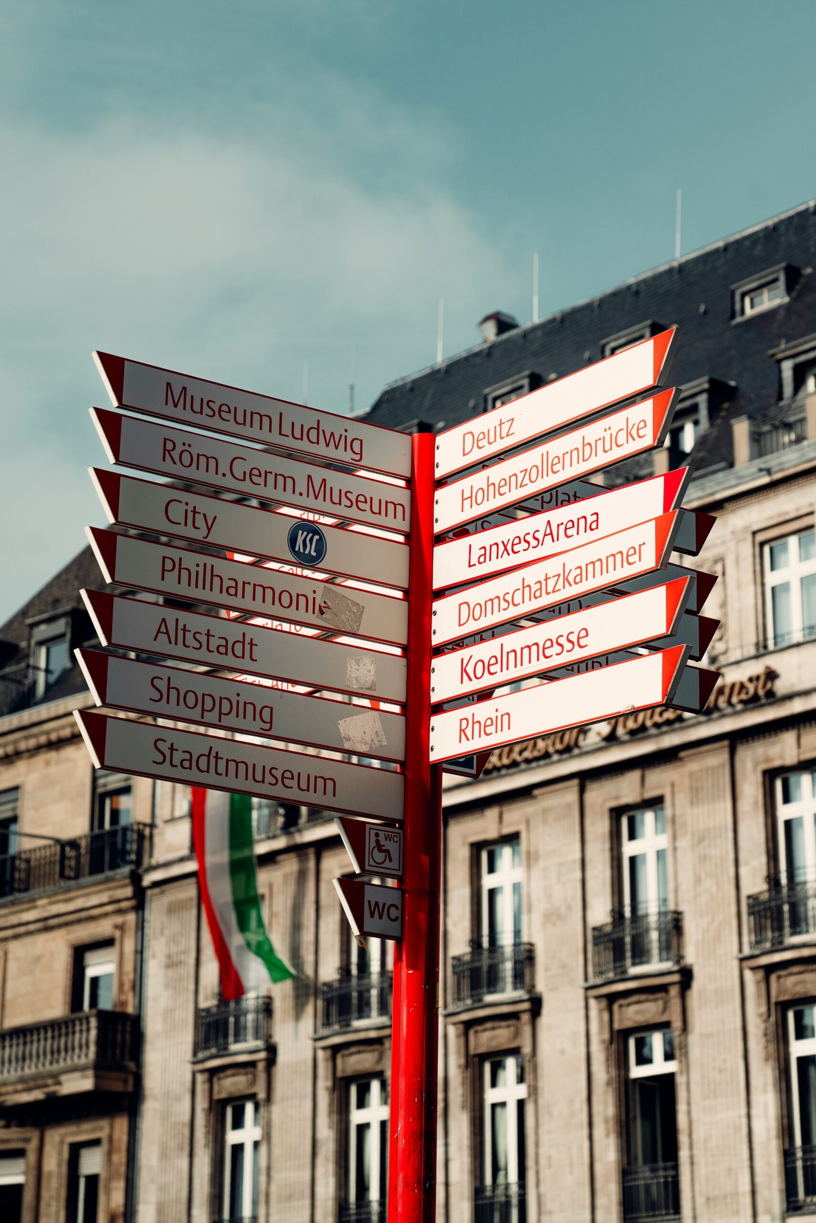 A street sign in front of a large building