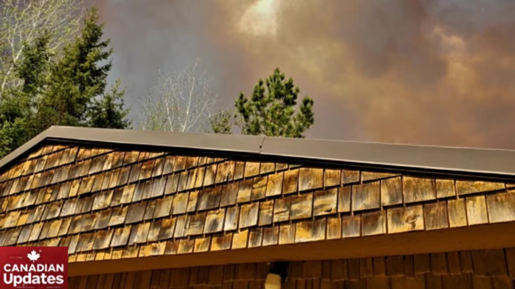 Wildfire burning near Lac du Bonnet, Manitoba, with smoke and flames visible in the distance.